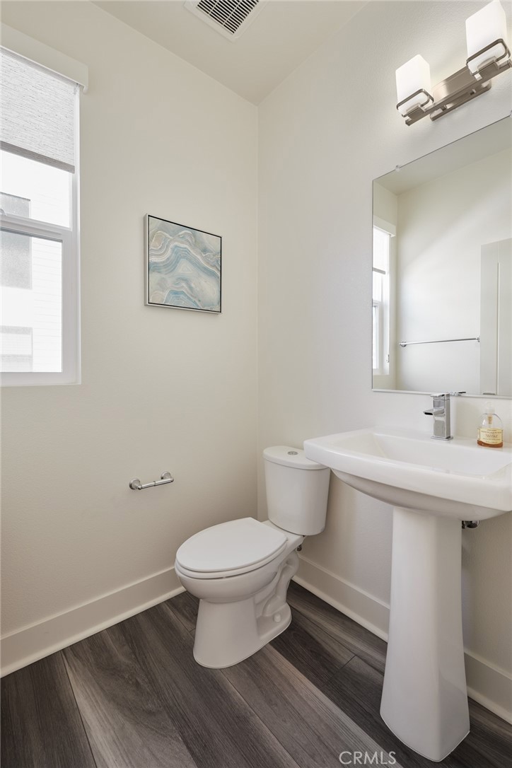 1648 Topanga Costa Mesa, CA 92627 - Photo 15 of 33 a bathroom with a sink toilet and a mirror