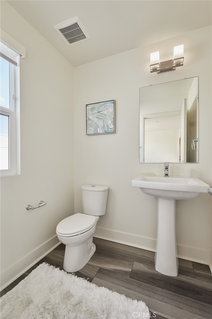 1648 Topanga Costa Mesa, CA 92627 - Photo 25 of 33 a bathroom with a toilet sink and mirror