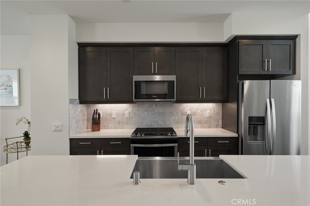 1648 Topanga Costa Mesa, CA 92627 - Photo 10 of 33 a kitchen with a sink and stainless steel appliances