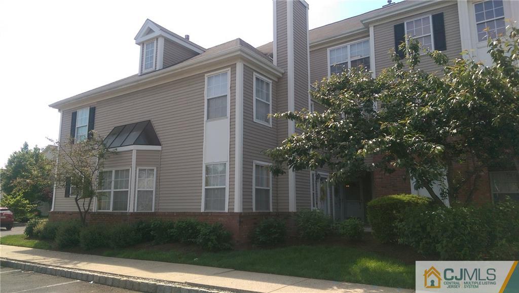 2101 Ridgeview Court, Unit 1 Sayreville, NJ 08859 - Photo 2 of 11 a front view of a house with plants and trees