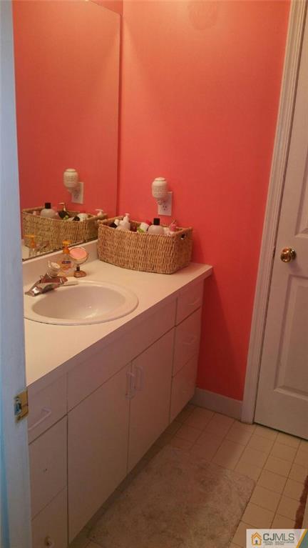 2101 Ridgeview Court, Unit 1 Sayreville, NJ 08859 - Photo 11 of 11 a bathroom with a sink and a mirror