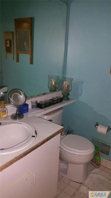 2101 Ridgeview Court, Unit 1 Sayreville, NJ 08859 - Photo 6 of 11 a bathroom with a sink toilet and a mirror