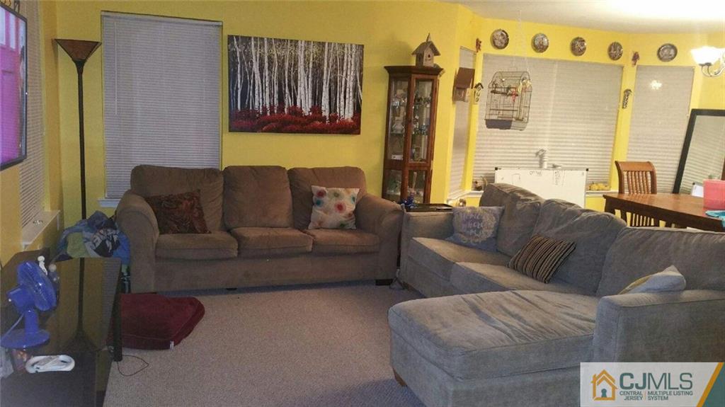 2101 Ridgeview Court, Unit 1 Sayreville, NJ 08859 - Photo 7 of 11 a living room with furniture and a bed
