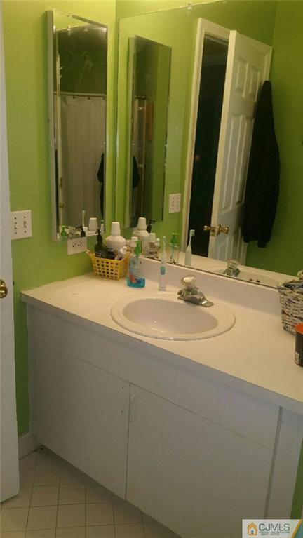 2101 Ridgeview Court, Unit 1 Sayreville, NJ 08859 - Photo 8 of 11 a bathroom with a sink and a mirror