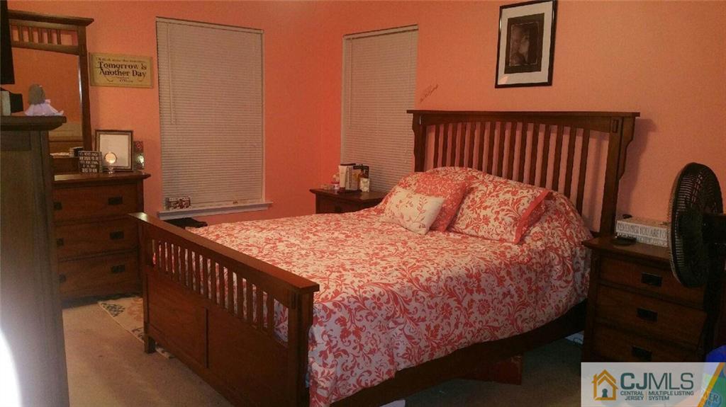 2101 Ridgeview Court, Unit 1 Sayreville, NJ 08859 - Photo 10 of 11 a bedroom with a bed and wooden floor
