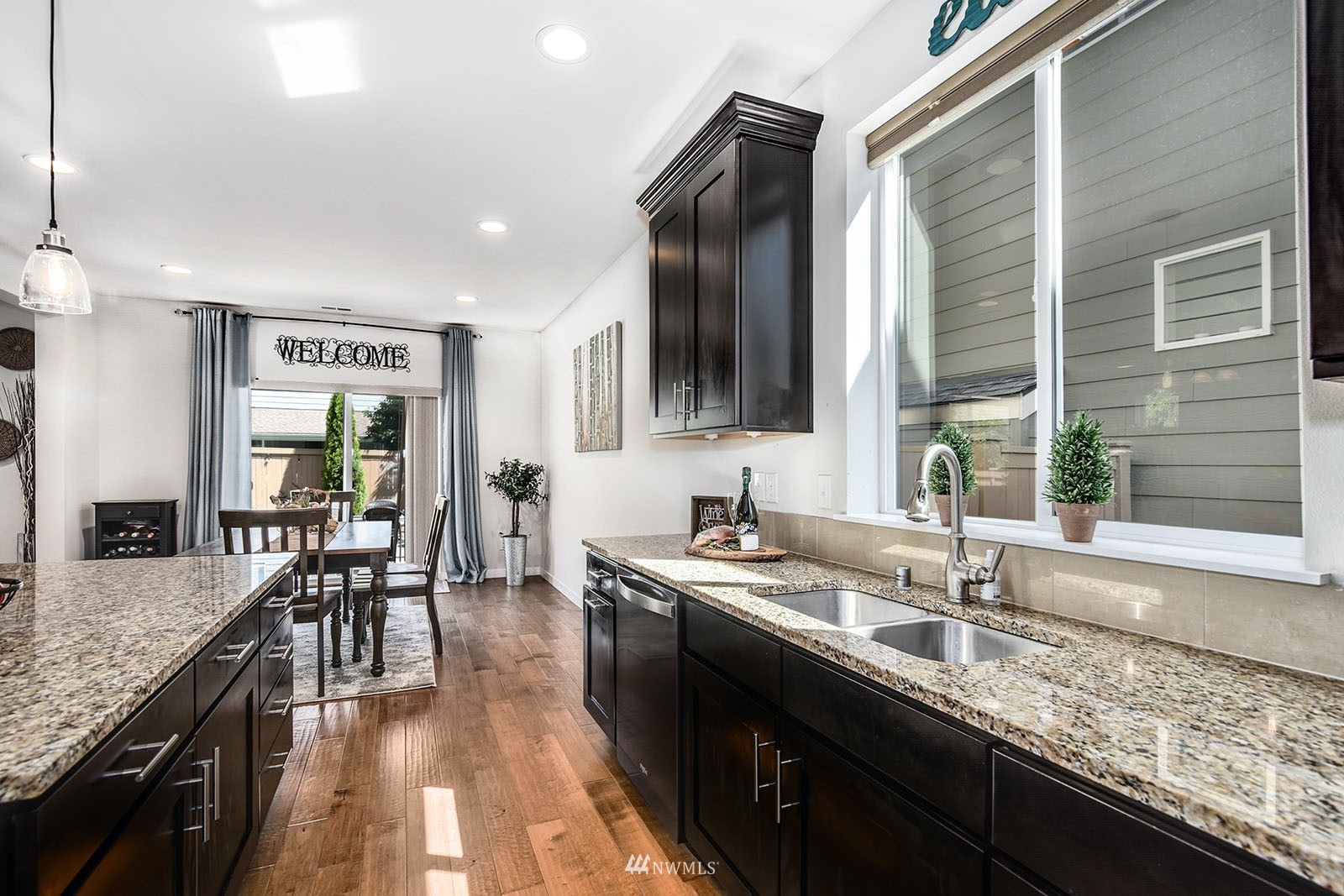24220 Southeast 258th Way Maple Valley, WA 98038 - Photo 12 of 28 a kitchen with granite countertop lots of counter top space and dining table