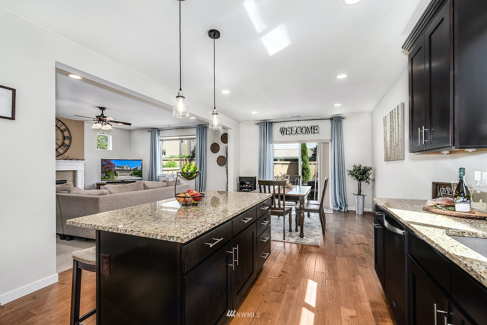 24220 Southeast 258th Way Maple Valley, WA 98038 - Photo 13 of 28 a kitchen with granite countertop kitchen island wooden cabinets and stainless steel appliances