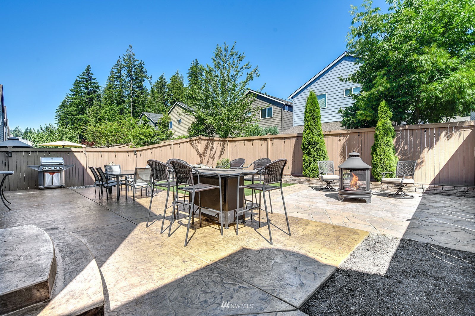 24220 Southeast 258th Way Maple Valley, WA 98038 - Photo 25 of 28 a view of a patio with table and chairs potted plants and palm tree