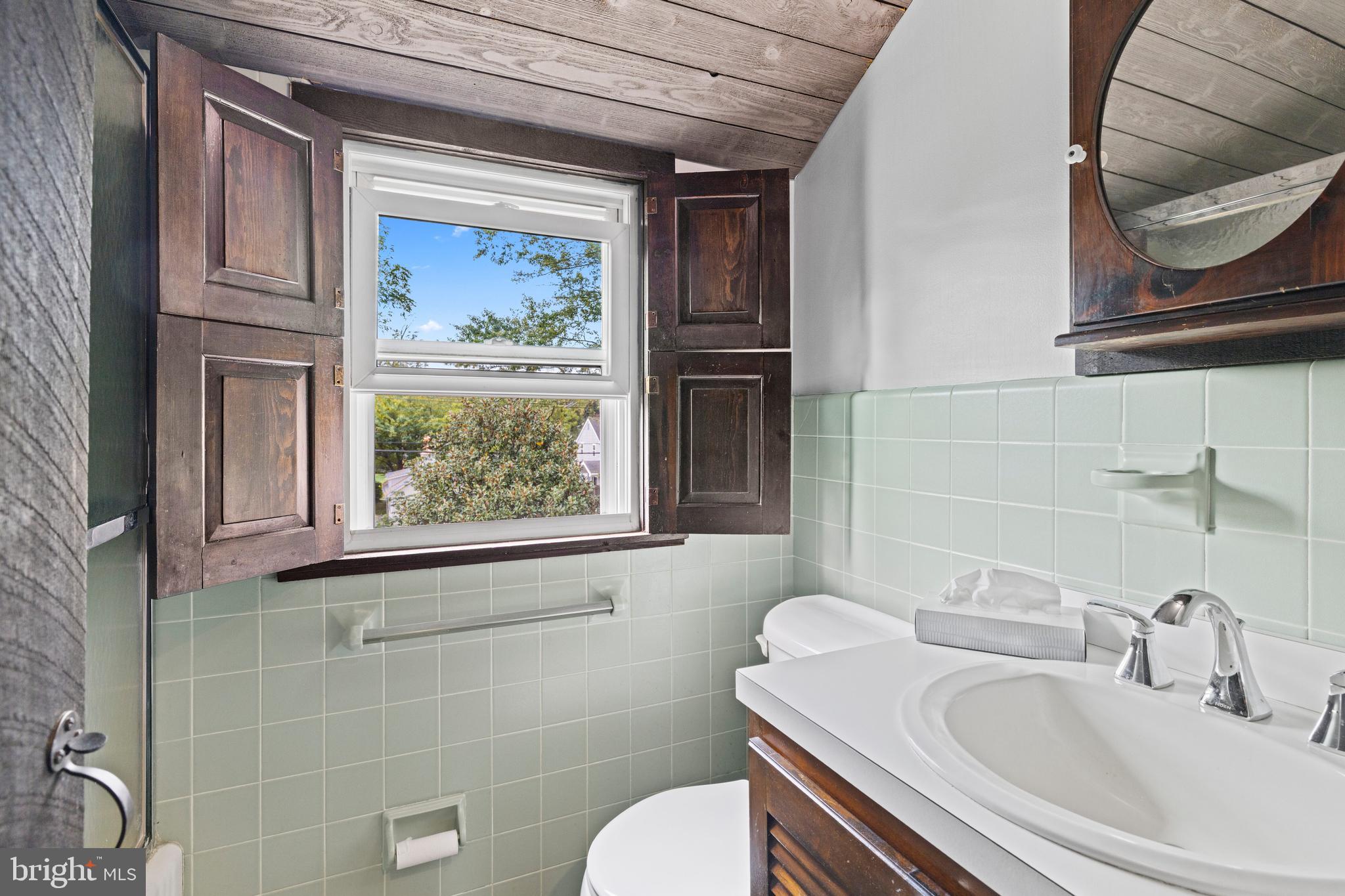 1508 Niessen Road Oreland, PA 19075 - Photo 16 of 44 a bathroom with a toilet a sink and mirror