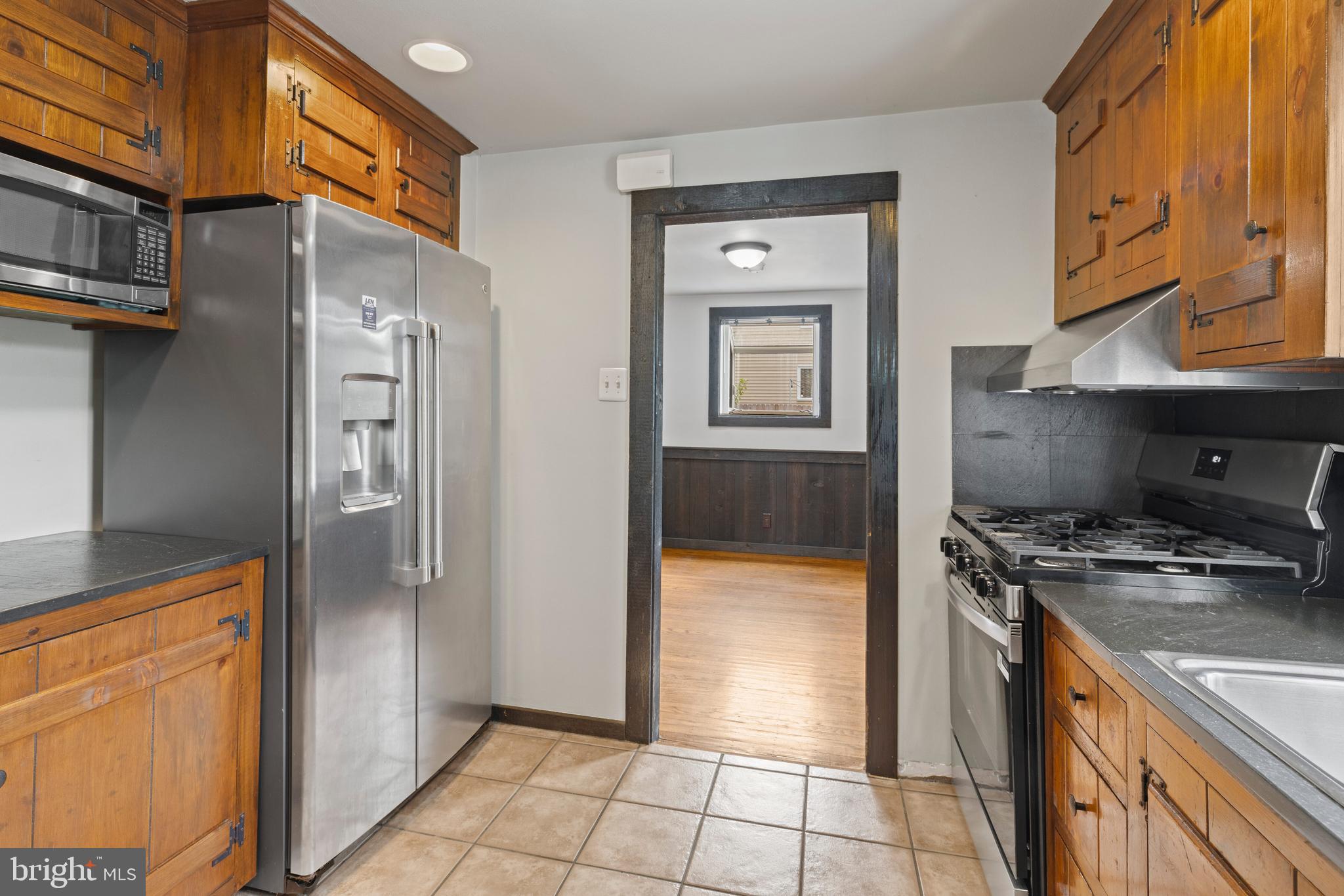 1508 Niessen Road Oreland, PA 19075 - Photo 9 of 44 a kitchen with stainless steel appliances granite countertop a refrigerator a stove and a sink