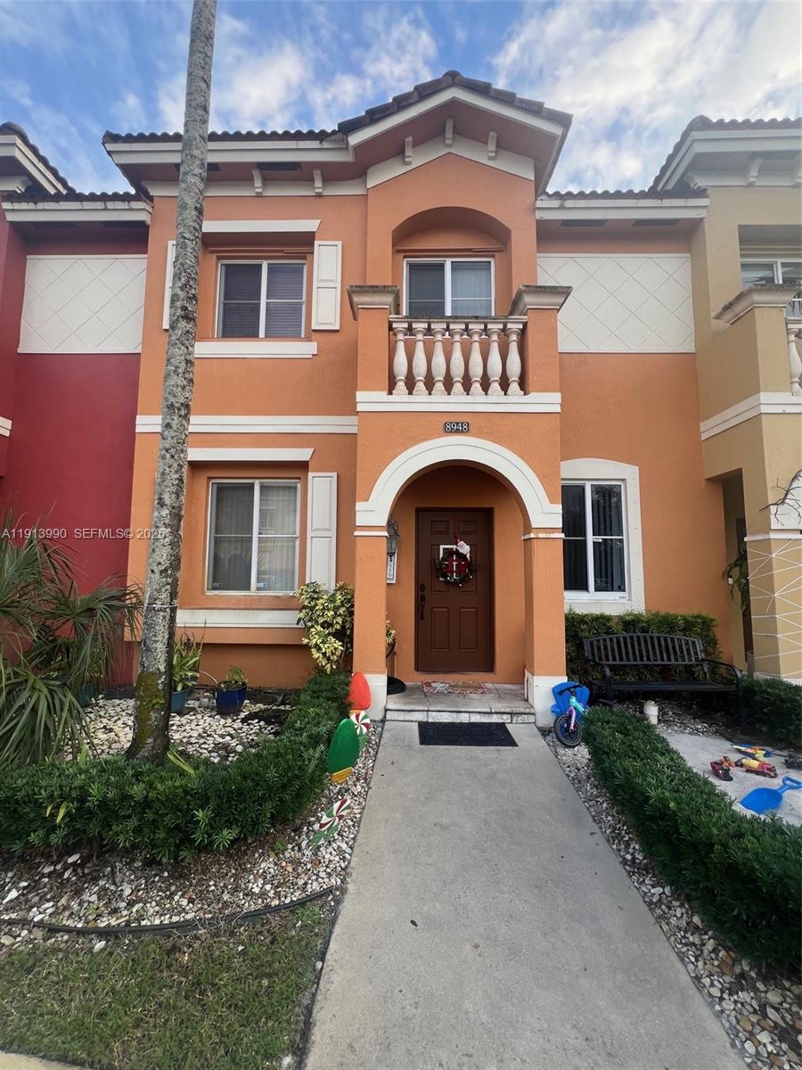 8948 Southwest 19th Street, Unit 909 Miramar, FL 33025 - Photo 19 of 31 a front view of a house with a yard