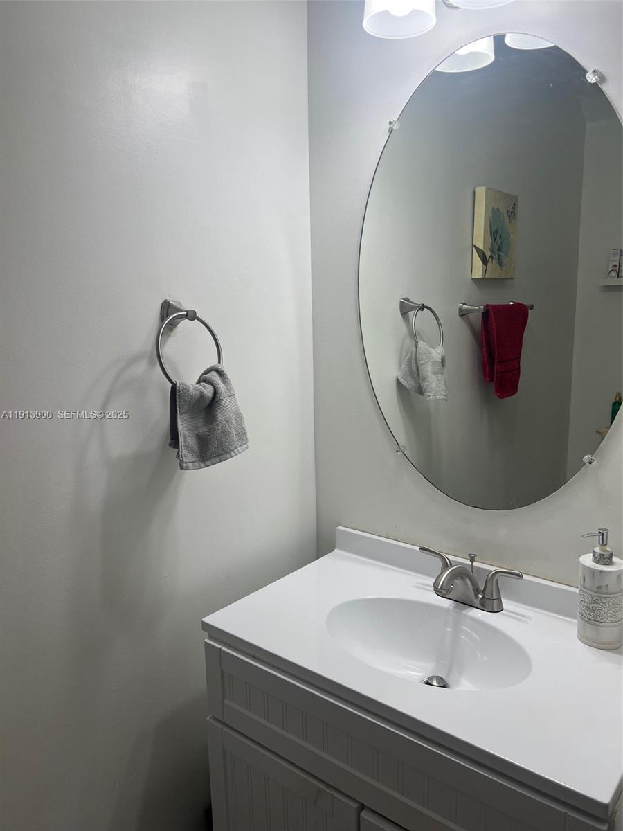 8948 Southwest 19th Street, Unit 909 Miramar, FL 33025 - Photo 22 of 31 a bathroom with a sink and mirror