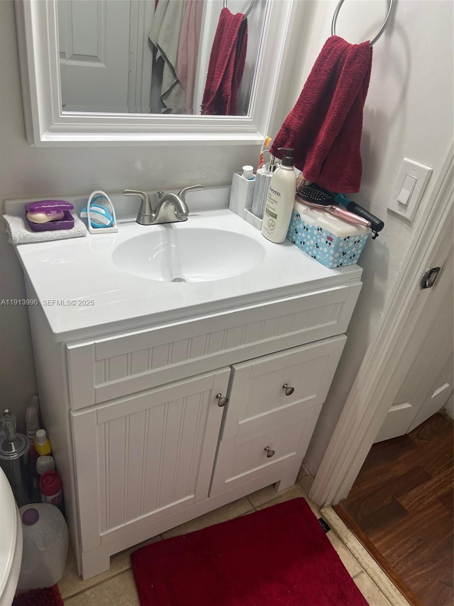 8948 Southwest 19th Street, Unit 909 Miramar, FL 33025 - Photo 24 of 31 a bathroom with a sink and a mirror