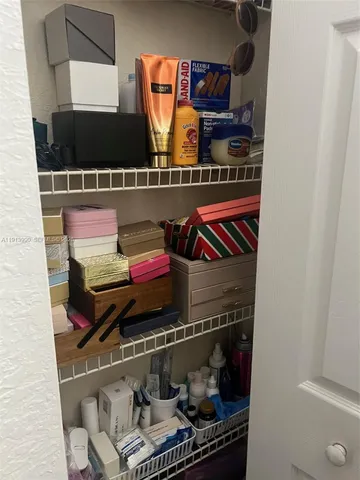 a view of a patio with table and chairs under an umbrella with a small yard