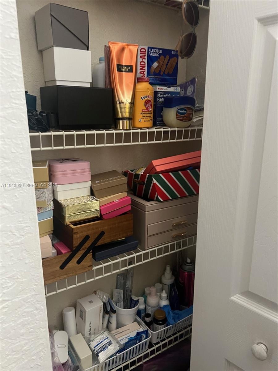 8948 Southwest 19th Street, Unit 909 Miramar, FL 33025 - Photo 25 of 31 a room with lots of different colored cloths