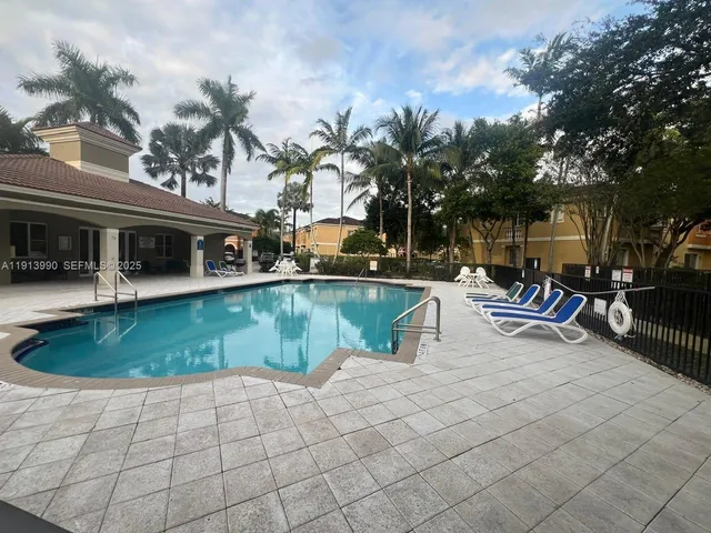 a view of a patio with couches table and chairs and potted plants