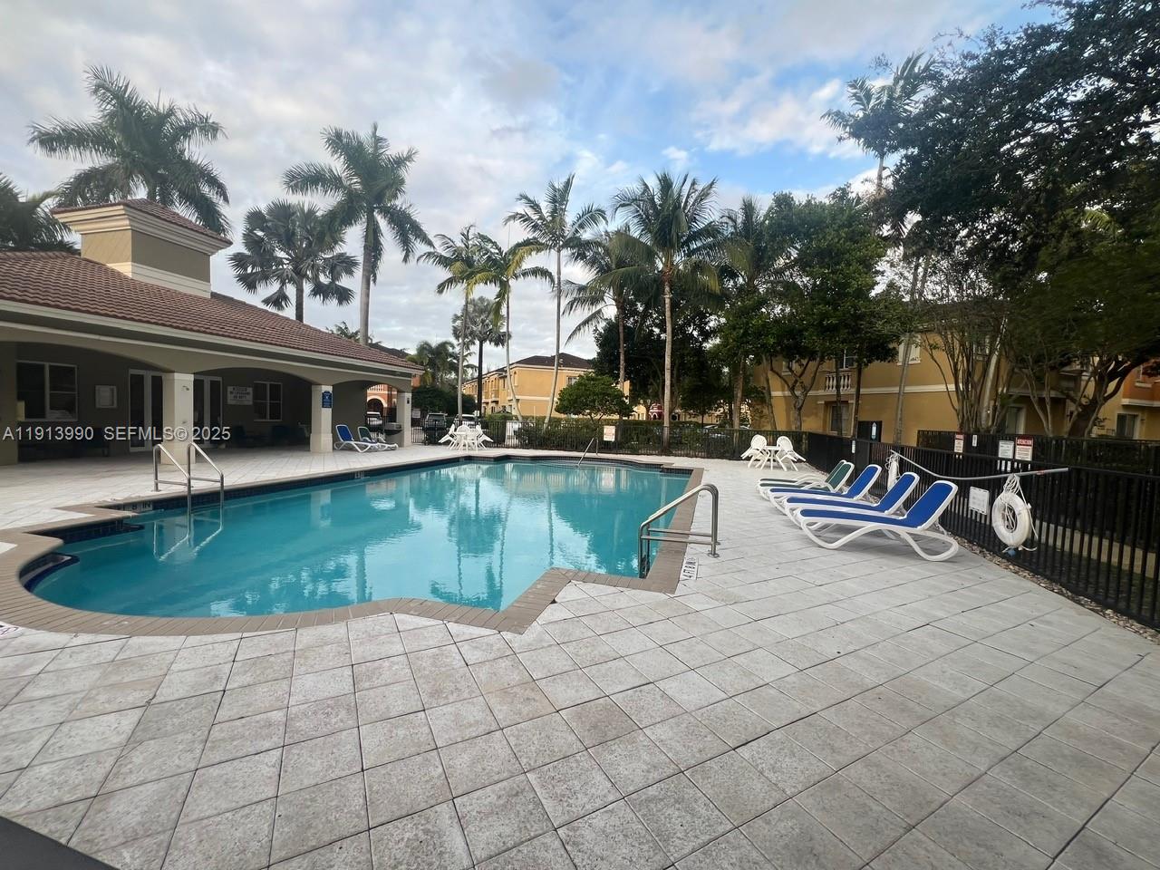 8948 Southwest 19th Street, Unit 909 Miramar, FL 33025 - Photo 26 of 31 a view of a swimming pool with outdoor seating