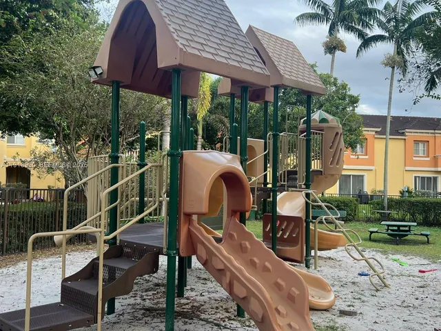 a view of street with a building and trees in the background