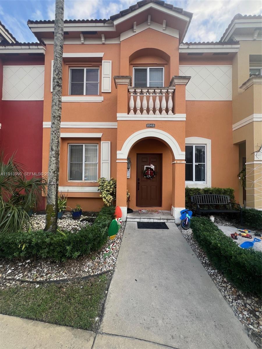 8948 Southwest 19th Street, Unit 909 Miramar, FL 33025 - Photo 3 of 31 a front view of a house with garden