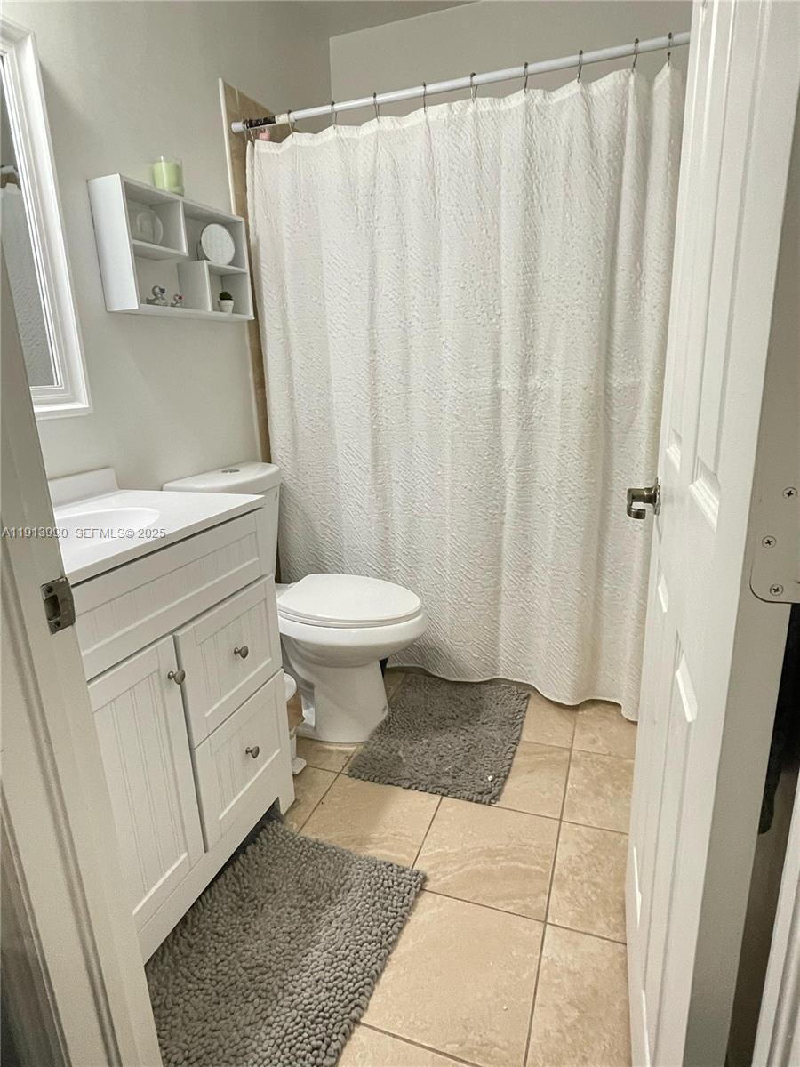 8948 Southwest 19th Street, Unit 909 Miramar, FL 33025 - Photo 9 of 31 a bathroom with a sink toilet and shower