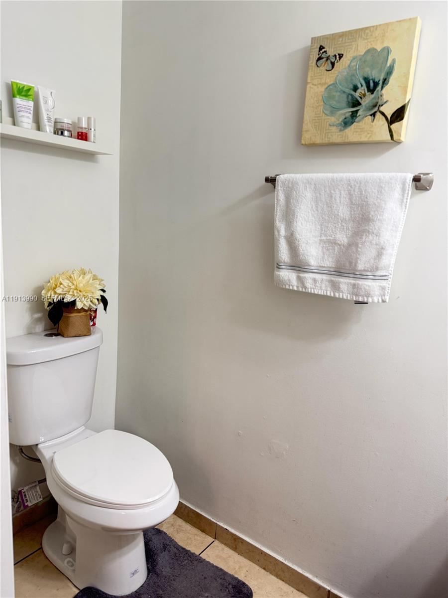 8948 Southwest 19th Street, Unit 909 Miramar, FL 33025 - Photo 10 of 31 a bathroom with a toilet and a sink