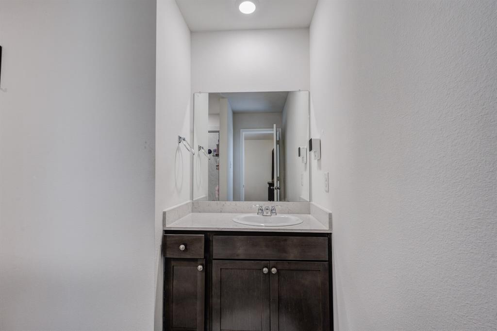 806 Ramble Road Lavon, TX 75166 - Photo 11 of 24 a bathroom with a sink and a mirror