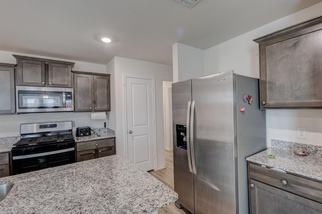 806 Ramble Road Lavon, TX 75166 - Photo 15 of 24 a kitchen with a refrigerator stove and sink