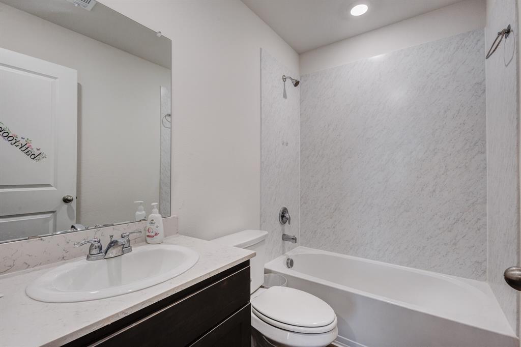 806 Ramble Road Lavon, TX 75166 - Photo 17 of 24 a bathroom with a granite countertop sink toilet and shower