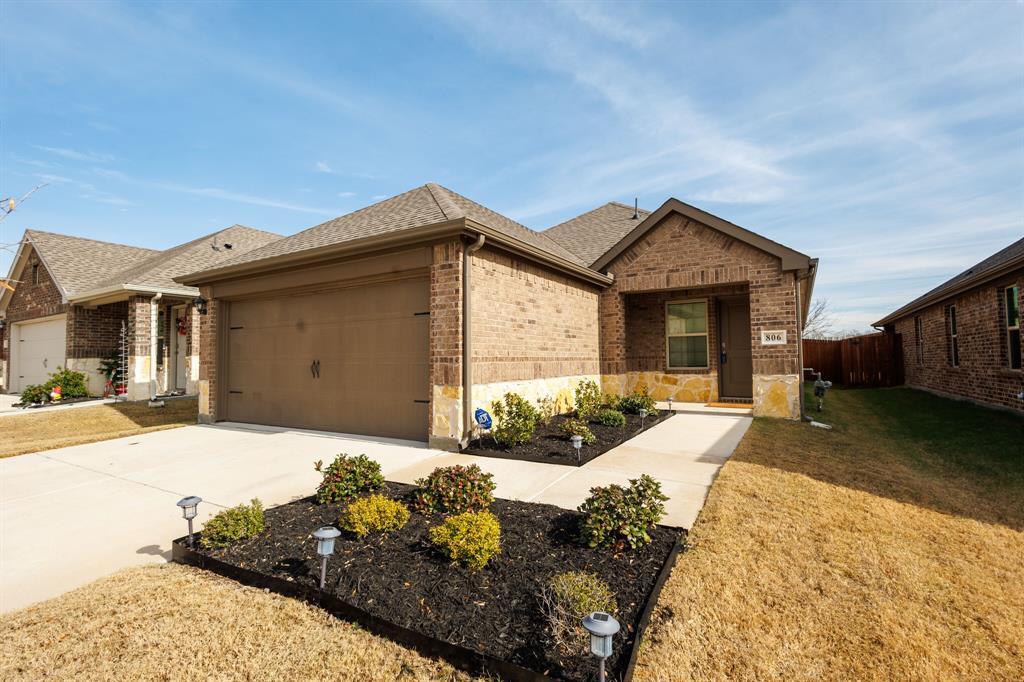 806 Ramble Road Lavon, TX 75166 - Photo 3 of 24 a front view of a house with a yard