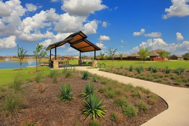 a view of a garden with a house