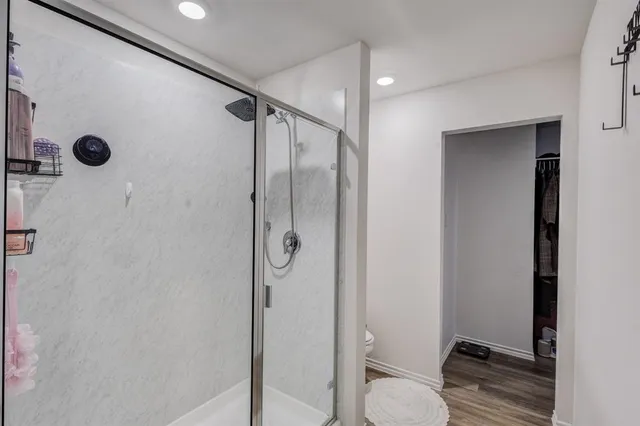 a bathroom with a shower and a toilet
