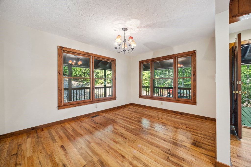 101 Menagerie Ridge Epworth, GA 30541 - Photo 15 of 48 a view of an empty room with wooden floor and a window