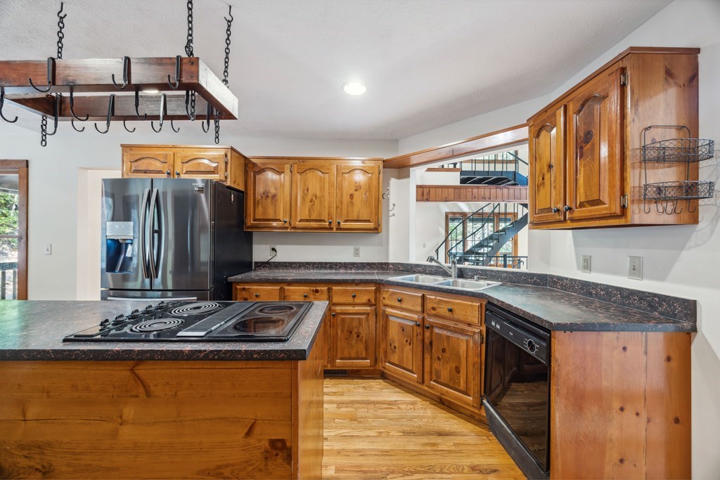 101 Menagerie Ridge Epworth, GA 30541 - Photo 20 of 48 a kitchen with stainless steel appliances granite countertop a sink a stove and a wooden cabinets