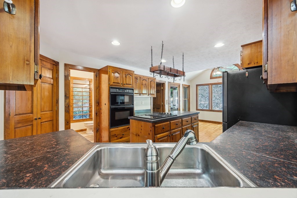 101 Menagerie Ridge Epworth, GA 30541 - Photo 21 of 48 a kitchen with stainless steel appliances granite countertop a refrigerator and a sink
