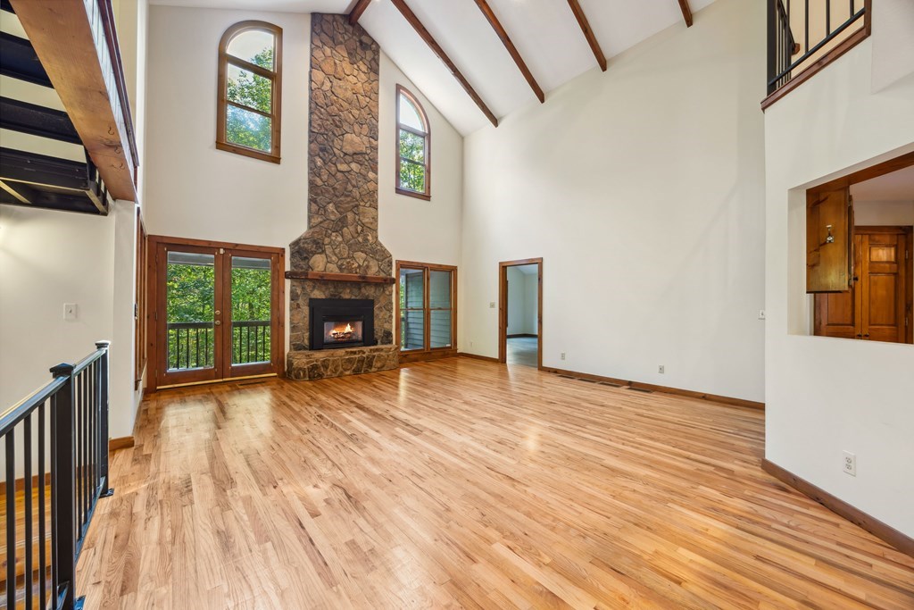 101 Menagerie Ridge Epworth, GA 30541 - Photo 4 of 48 a view of an empty room with wooden floor fireplace and a window