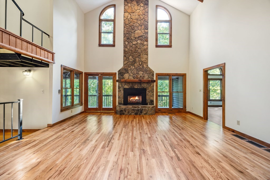 101 Menagerie Ridge Epworth, GA 30541 - Photo 5 of 48 a view of an empty room with wooden floor fireplace and a window