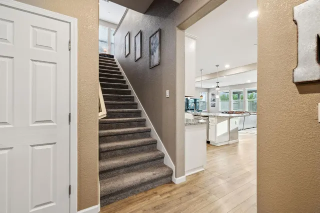 a kitchen with stainless steel appliances kitchen island granite countertop a sink and refrigerator