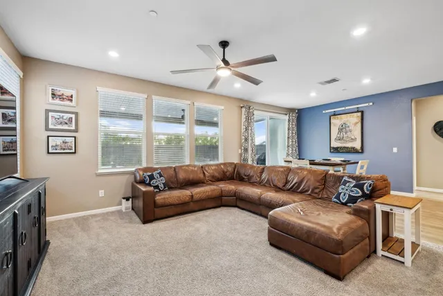 a bed sitting in a spacious bedroom next to a window