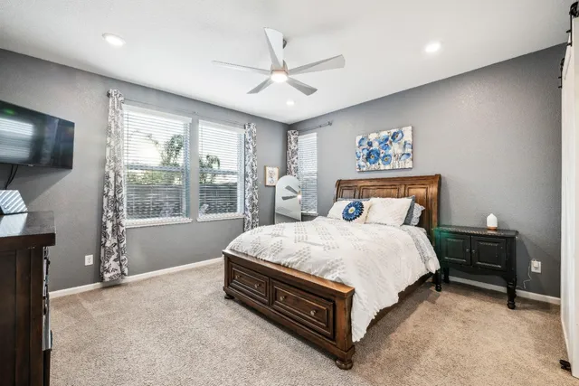 a white bath tub sitting in a bathroom next to a window