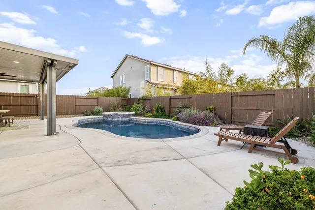 a bathroom with a sink a toilet a mirror and shower