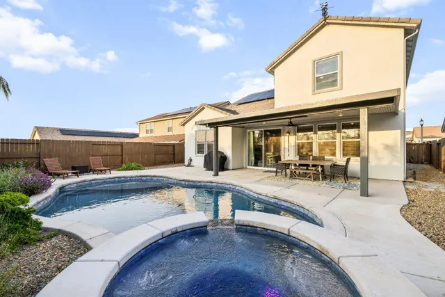 a bedroom with a bed and a ceiling fan