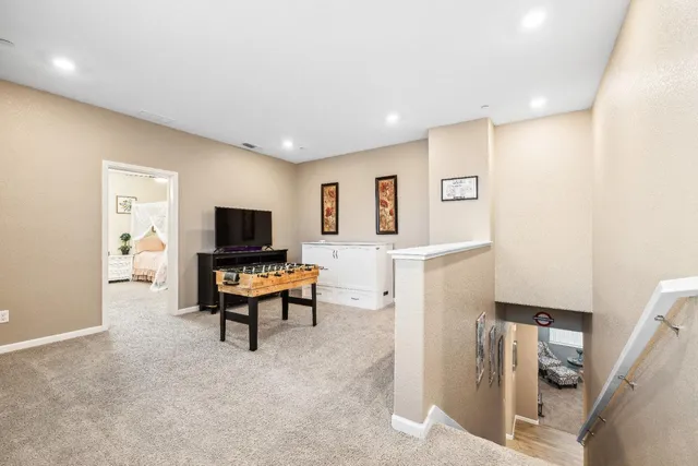 a view of a patio with a table chairs potted plants and palm trees