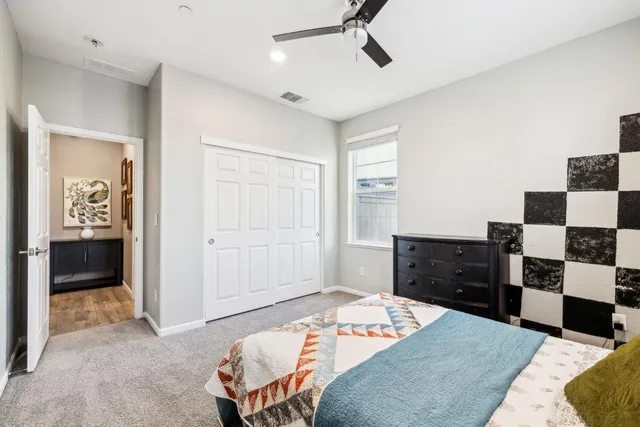 a bedroom with a bed and a window