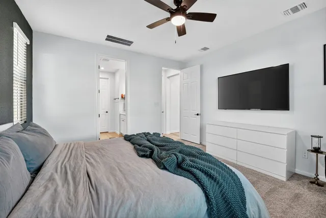 a bedroom with a bed and a flat screen tv