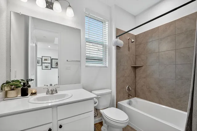 a bathroom with a sink toilet a mirror and shower