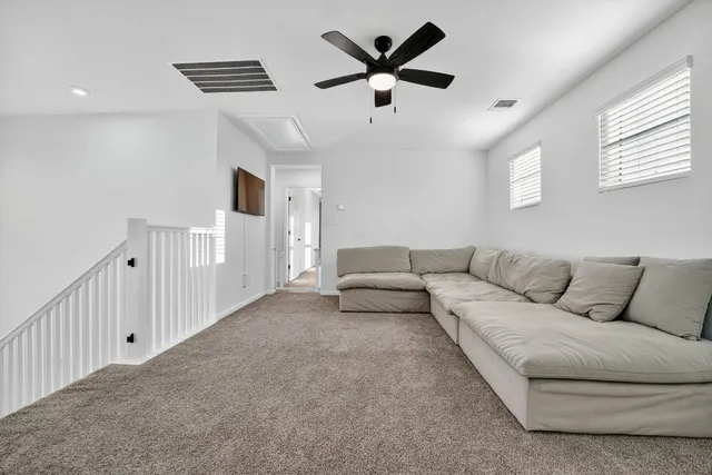 a living room with a baby crib and a window