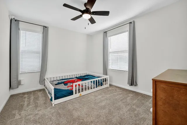 a bedroom with bed and window