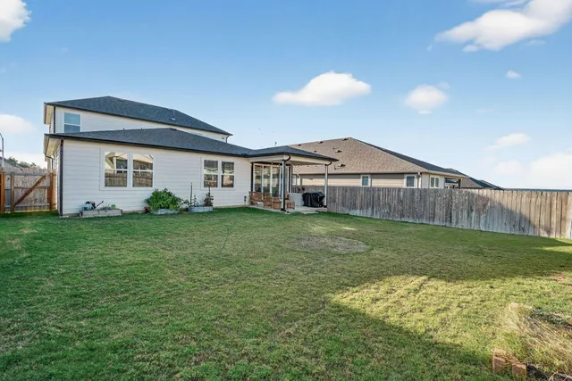 a backyard of a house with table and chairs
