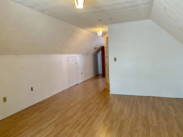 a view of a room with wooden floor