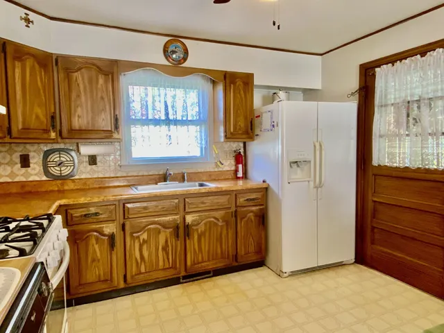 a kitchen with a refrigerator and a sink